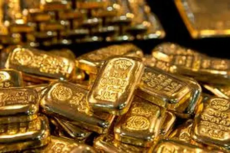 Gold dips as dollar firms, investors eye US fiscal woes, rate signals